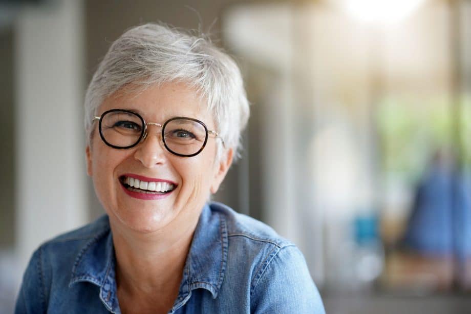 Woman smiling with a healthy smile after oral pathology in Milwaukee WI